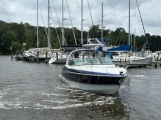 Slide: The Image of 2012 Formula 350 Sun Sport boat navigating marina with sailboats in background. - 41