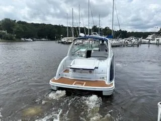 Slide: The Image of 2012 Formula 350 Sun Sport boat cruising in a marina with sailboats in the background. - 5