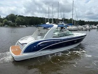 Slide: The Image of 2012 Formula 350 Sun Sport boat on a calm lake with marina background. - 9