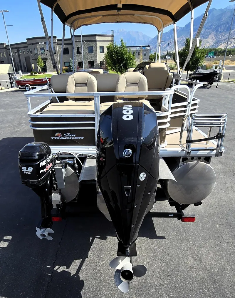 Slide: The Image of 2023 Sun Tracker SportFish 22 XP3 pontoon boat with dual Mercury outboard motors. - 10