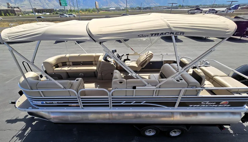 Slide: The Image of 2023 Sun Tracker SportFish 22 XP3 pontoon boat with beige seating and canopy. - 13