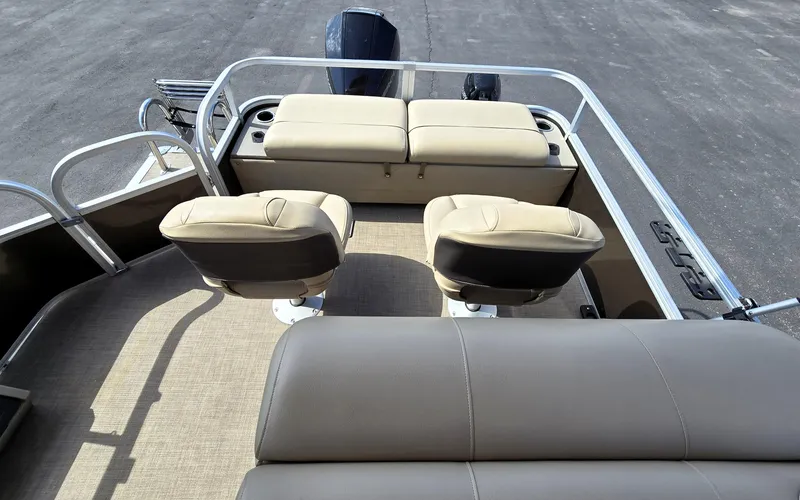 Slide: The Image of 2023 Sun Tracker SportFish 22 XP3 boat interior with beige seating and steering console. - 16
