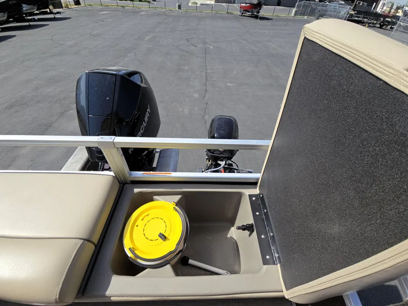 Slide: The Image of 2023 Sun Tracker SportFish 22 XP3 boat with storage compartment and Mercury outboard motor. - 17