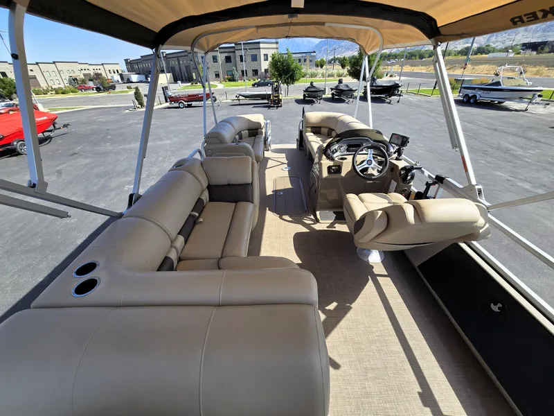 Slide: The Image of 2023 Sun Tracker SportFish 22 XP3 pontoon boat interior with beige seating and steering console. - 19