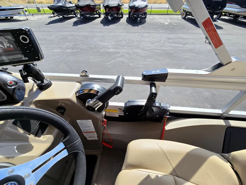 Slide: The Image of 2023 Sun Tracker SportFish 22 XP3 boat cockpit with steering wheel and controls. - 21