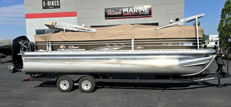 Slide: The Image of 2023 Sun Tracker SportFish 22 XP3 pontoon boat parked at Utah Marine Store. - 25
