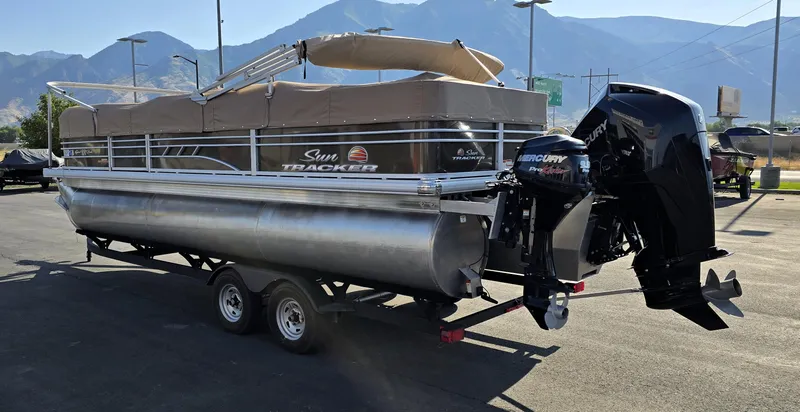 Slide: The Image of 2023 Sun Tracker SportFish 22 XP3 pontoon boat with Mercury outboard motor on trailer. - 29
