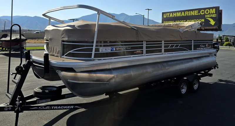 Slide: The Image of 2023 Sun Tracker SportFish 22 XP3 pontoon boat on trailer, covered, at Utah Marine dealership. - 30