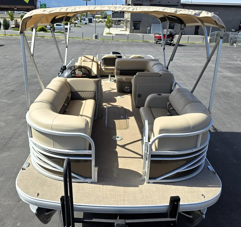 Slide: The Image of 2023 Sun Tracker SportFish 22 XP3 pontoon boat with beige seating and canopy. - 8