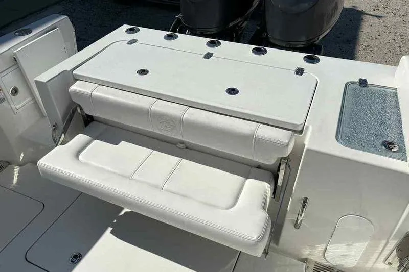 Slide: The Image of 2026 Parker 2900 CC boat with foldable white seating and storage compartments. - 10