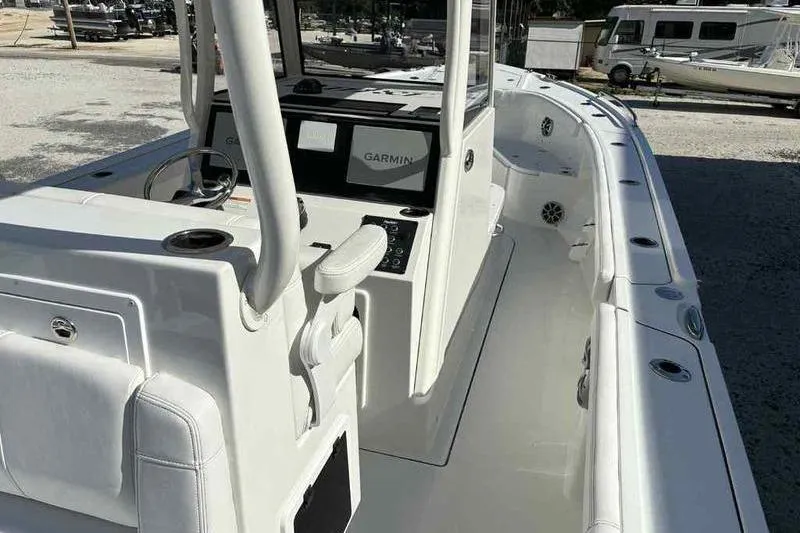 Slide: The Image of 2026 Parker 2900 CC boat interior with Garmin navigation system, white seating, and spacious deck. - 11