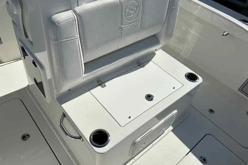 Slide: The Image of 2026 Parker 2900 CC boat seating with storage and cup holders. - 13