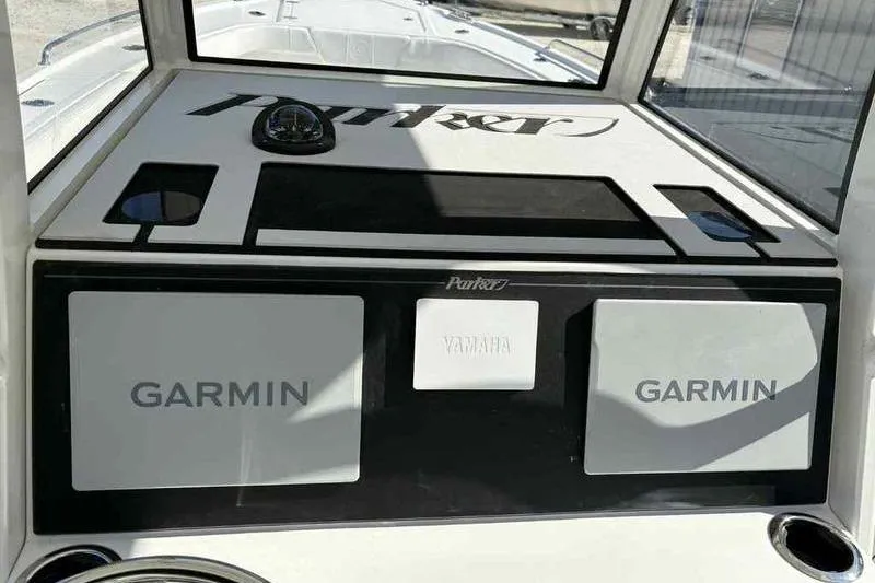 Slide: The Image of 2026 Parker 2900 CC boat dashboard with Garmin and Yamaha displays. - 17