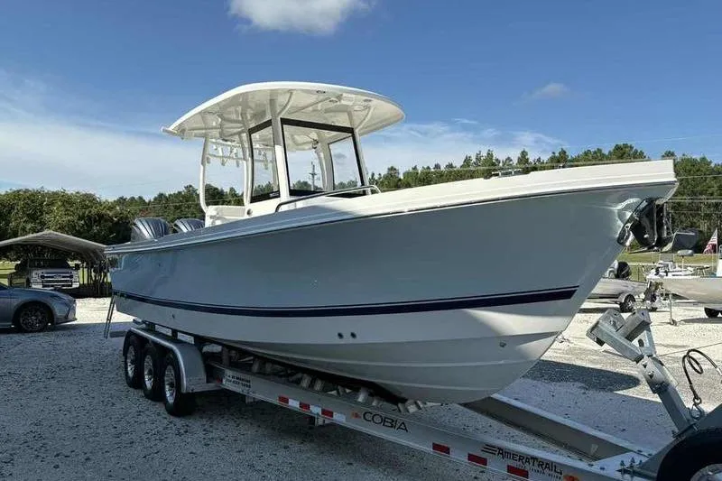 Slide: The Image of 2026 Parker 2900 CC boat on trailer under clear blue sky. - 6