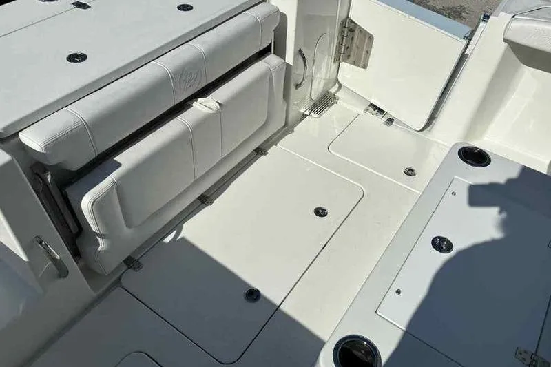 Slide: The Image of 2026 Parker 2900 CC boat interior with foldable seating and storage compartments. - 7