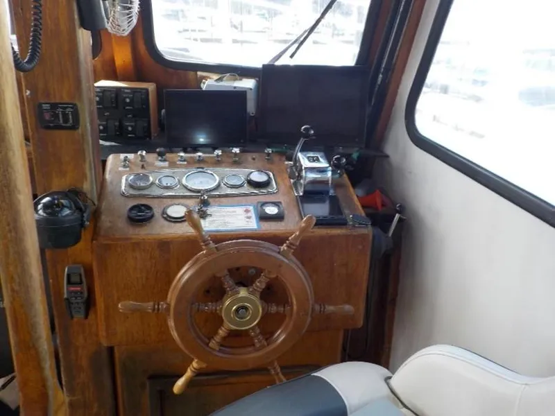 Slide: The Image of 1974 custom passenger vessel helm with wooden wheel and control panel. - 11