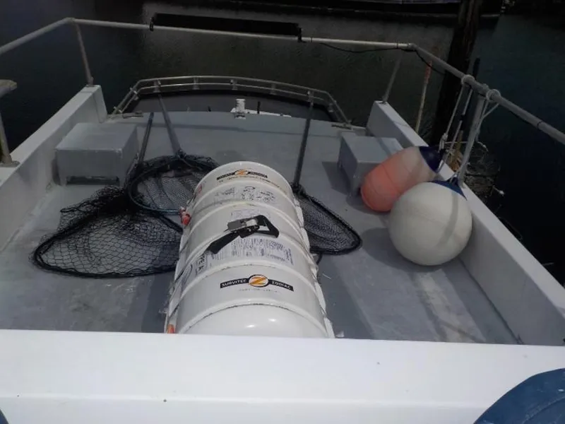 Slide: The Image of 1974 custom passenger vessel deck with liferaft, nets, and buoys. - 16