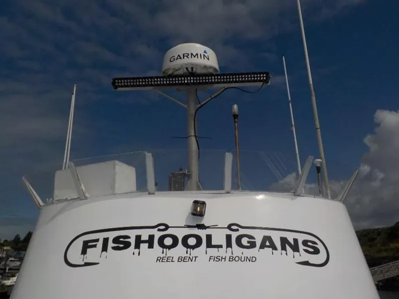 Slide: The Image of Custom 1974 passenger vessel "Fishooligans" with Garmin equipment against a cloudy sky. - 3
