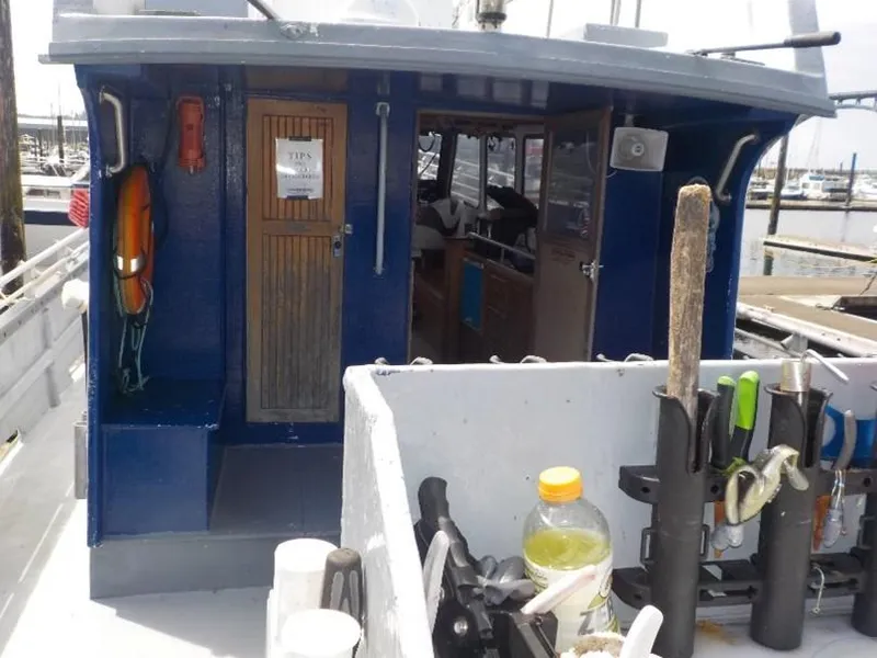 Slide: The Image of 1974 custom passenger vessel with tools and equipment on deck, docked at a marina. - 5