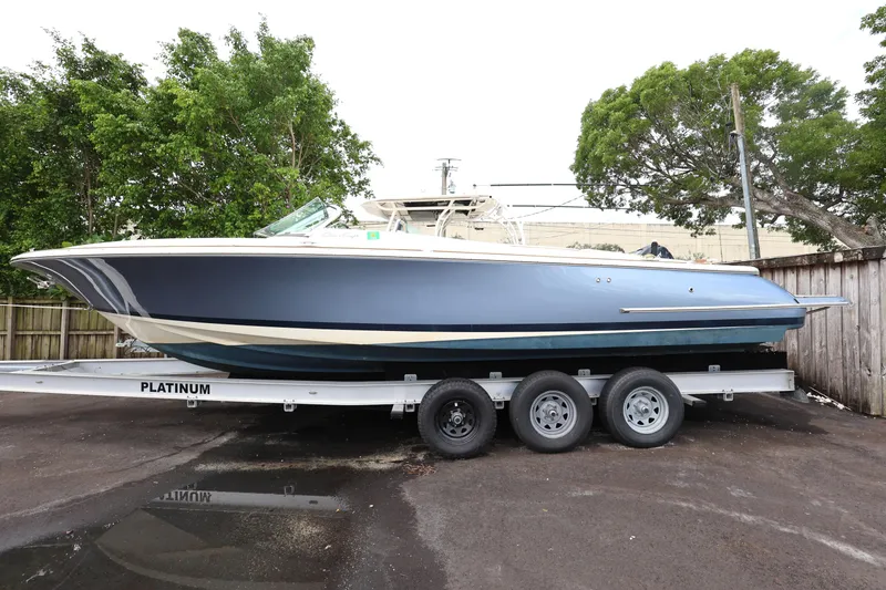 The Image of 2020 Chris-Craft 30 Launch boat on trailer, parked outdoors. - 1