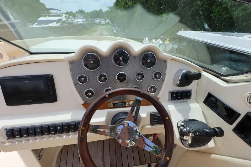 Slide: The Image of 2020 Chris-Craft 30 Launch dashboard with steering wheel and navigation controls. - 10