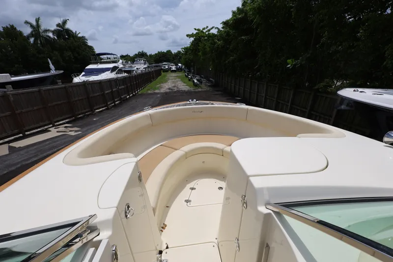 Slide: The Image of 2020 Chris-Craft 30 Launch boat with spacious seating, docked near other yachts. - 11