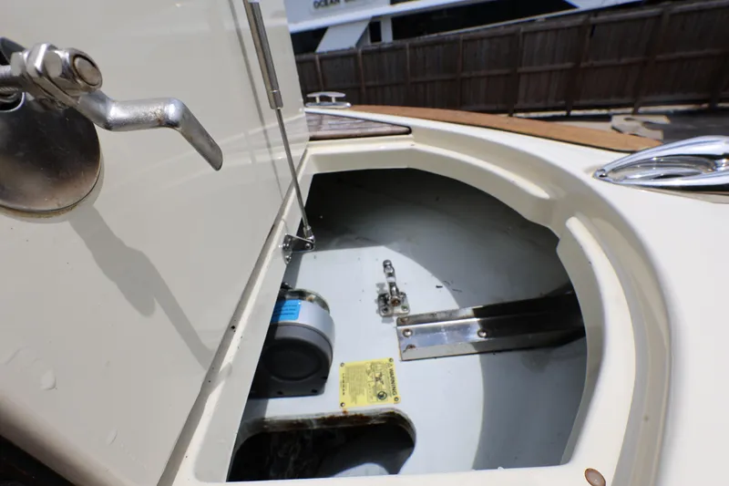 Slide: The Image of 2020 Chris-Craft 30 Launch boat storage compartment with metal latch and hydraulic support. - 13