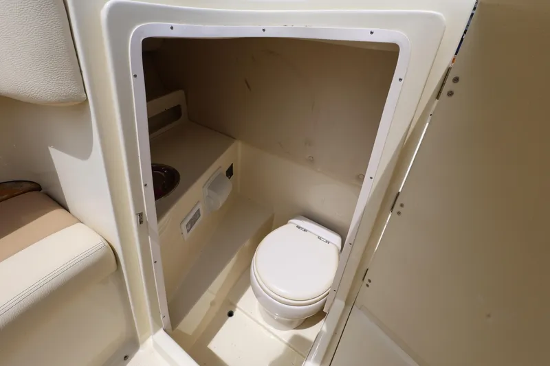Slide: The Image of 2020 Chris-Craft 30 Launch boat interior with compact marine toilet. - 15