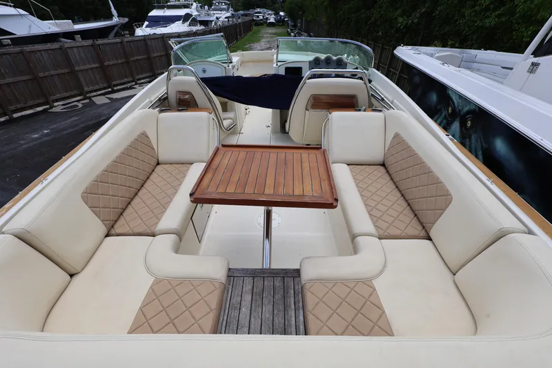 Slide: The Image of 2020 Chris-Craft 30 Launch boat interior with luxurious seating and wooden table. - 5