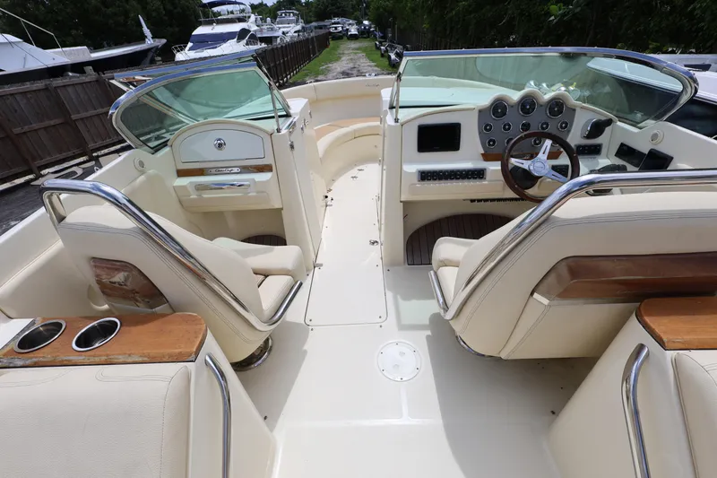 Slide: The Image of 2020 Chris-Craft 30 Launch boat interior with luxurious seating and modern dashboard. - 6