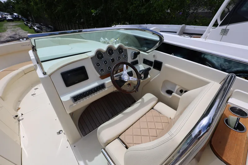 Slide: The Image of 2020 Chris-Craft 30 Launch boat cockpit with steering wheel and dashboard controls. - 8