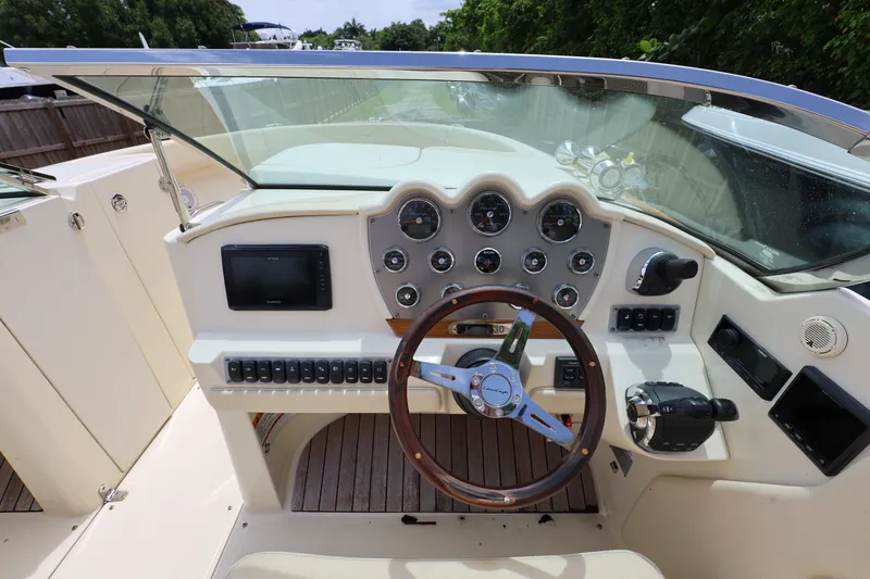 Slide: The Image of 2020 Chris-Craft 30 Launch boat dashboard with steering wheel and control panel. - 9