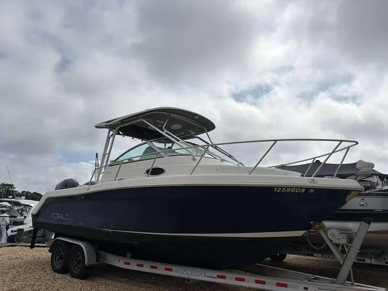 The Image of 2014 Robalo 265R boat on trailer under cloudy sky. - 1