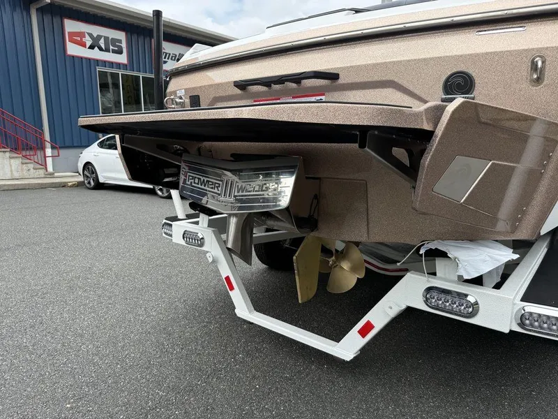 Slide: The Image of 2026 Axis A225 boat rear view with Power Wedge III, parked outside dealership. - 11
