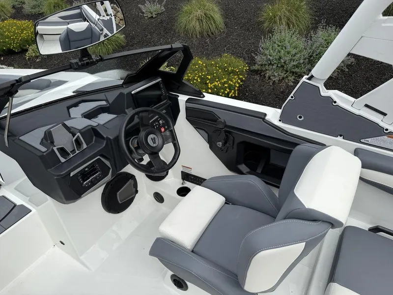Slide: The Image of Interior of 2026 Axis A225 boat with modern steering and seating. - 14