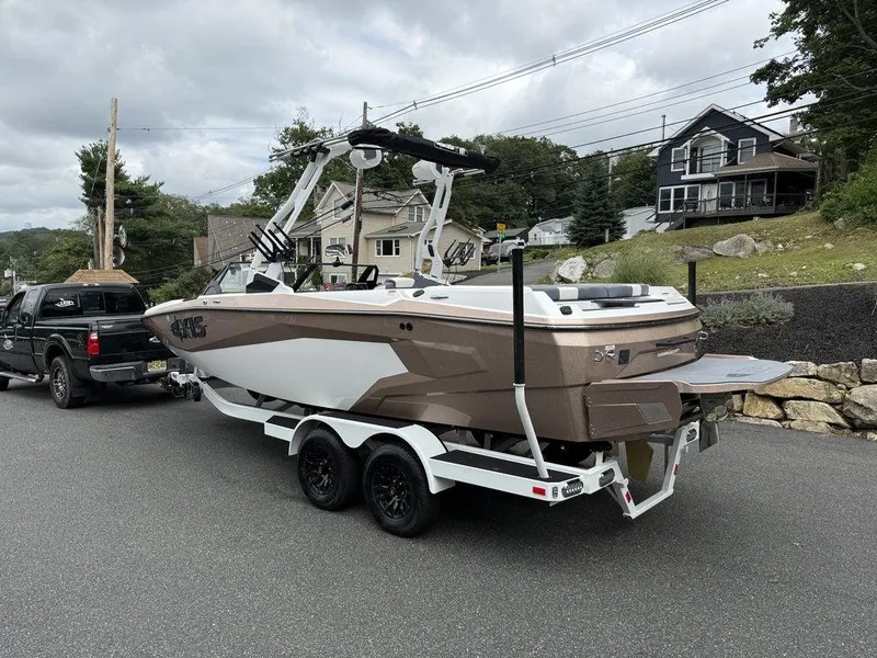 Slide: The Image of 2026 Axis A225 boat on trailer, parked on residential street. - 3