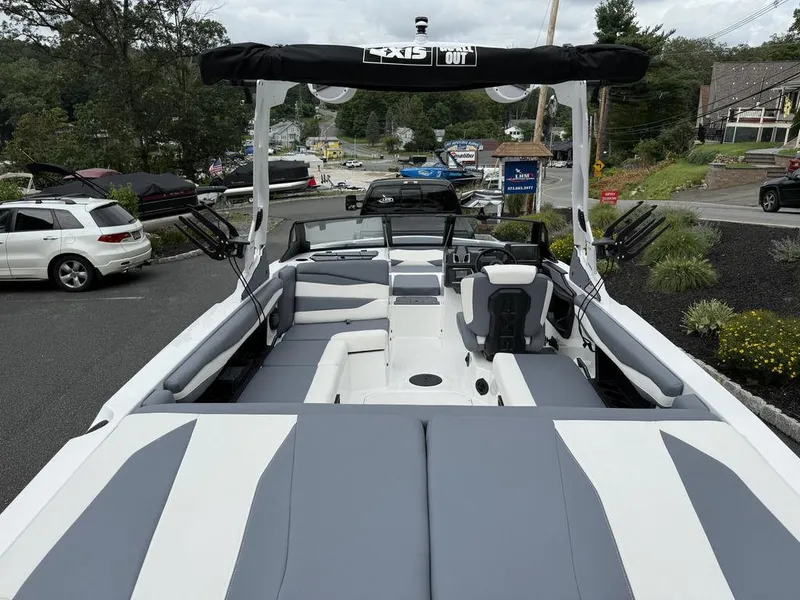 Slide: The Image of 2026 Axis A225 boat with sleek interior design, parked near a scenic road. - 4