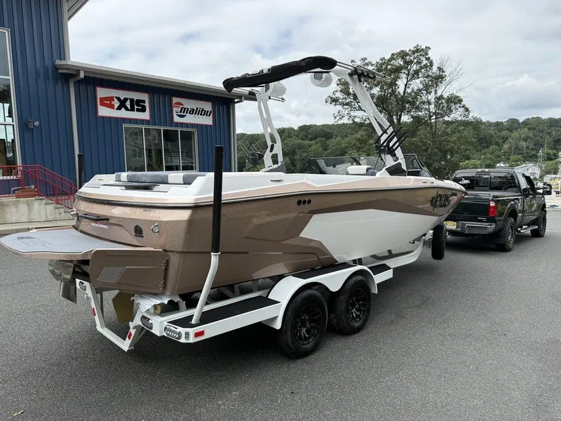 Slide: The Image of 2026 Axis A225 boat on trailer outside dealership, ready for transport. - 8