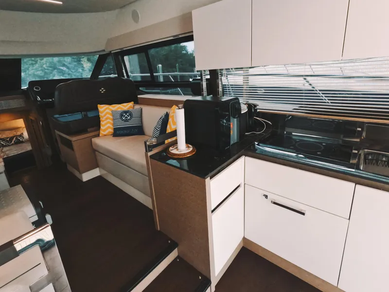 Slide: The Image of Interior of 2020 Prestige 460 yacht with modern kitchen and seating area. - 21