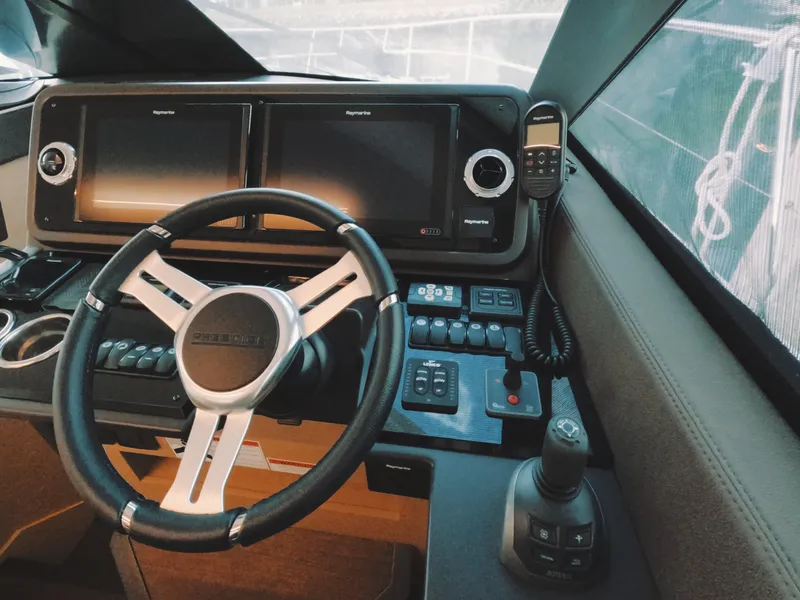 Slide: The Image of Prestige 460 yacht helm, 2020 model, featuring dual displays and modern controls. - 28