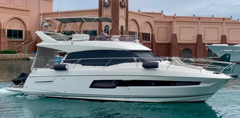 Slide: The Image of 2020 Prestige 460 yacht docked near elegant architecture. - 3