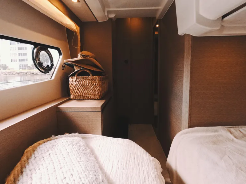 Slide: The Image of Cozy interior of 2020 Prestige 460 yacht cabin with natural light and woven basket. - 35