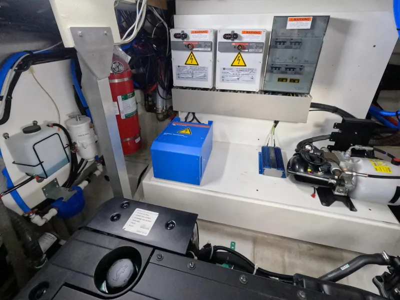 Slide: The Image of Engine room of 2020 Prestige 460 yacht with electrical panels and safety equipment. - 46