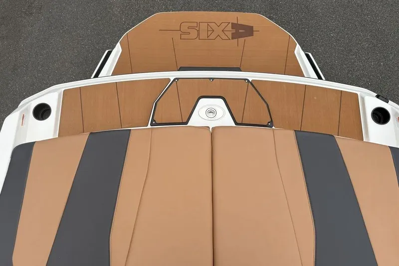 Slide: The Image of 2026 Axis A225 boat deck with tan and black upholstery, featuring sleek design elements. - 13