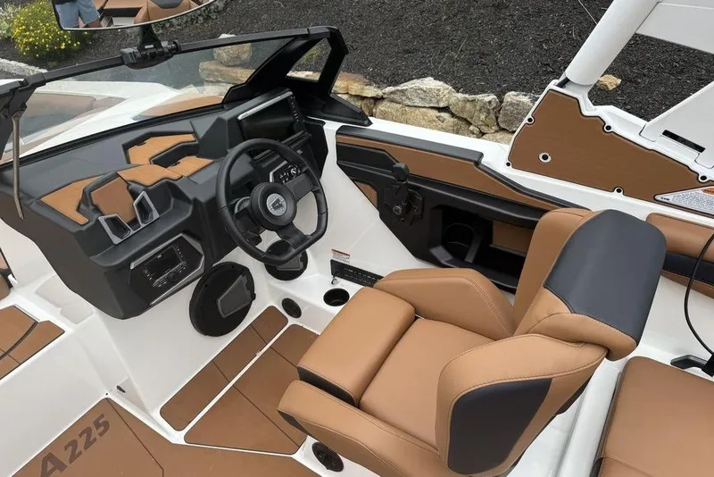 Slide: The Image of 2026 Axis A225 boat interior with tan and black seating, modern dashboard, and steering wheel. - 15