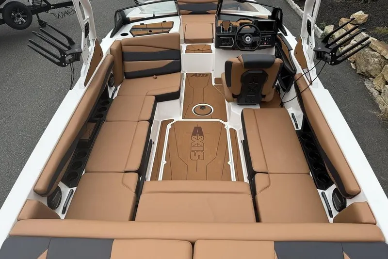 Slide: The Image of 2026 Axis A225 boat interior with tan seating and modern dashboard design. - 2