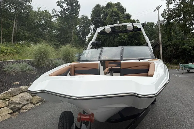 Slide: The Image of 2026 Axis A225 boat with sleek design and spacious seating, parked outdoors. - 4