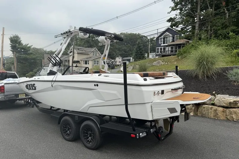Slide: The Image of 2026 Axis A225 boat on trailer, parked on residential street. - 5