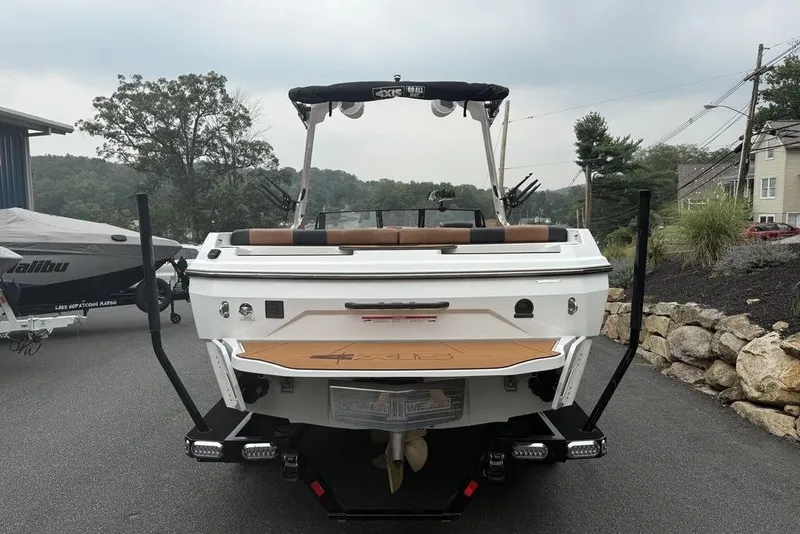 Slide: The Image of 2026 Axis A225 boat on trailer, parked outdoors near other boats. - 6