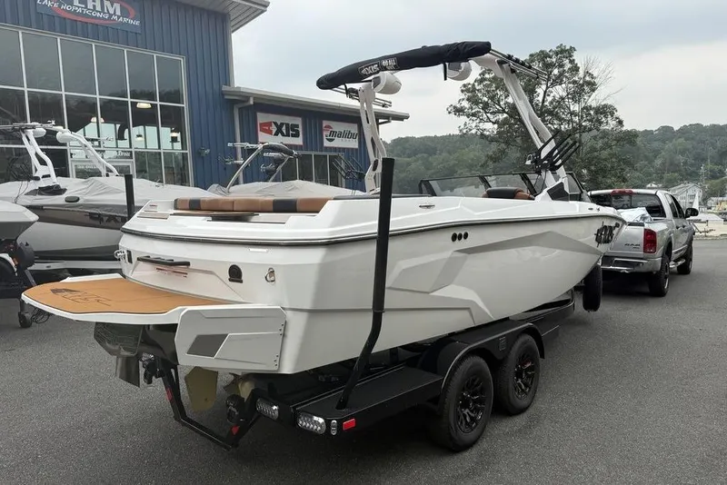Slide: The Image of 2026 Axis A225 boat on trailer, parked outside dealership, ready for transport. - 8